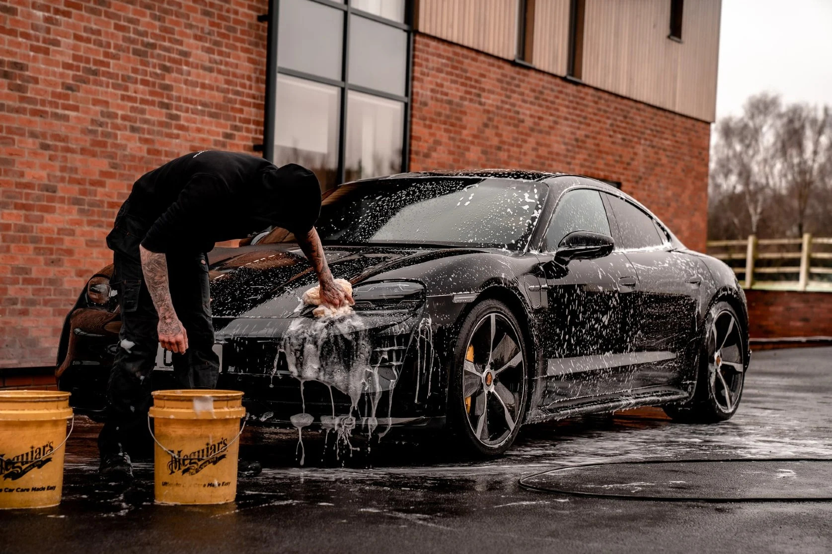 Full-vehicle hand wash on a black Porsche